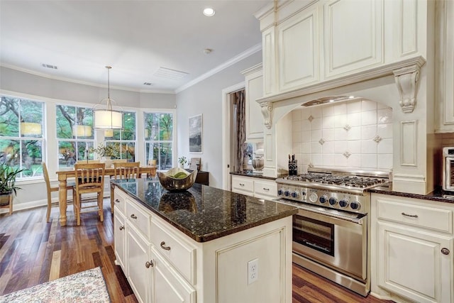 9301 San Lucas Dr, Austin, TX 78737 - kitchen featuring high end stainless steel range, dark wood finished floors, tasteful backsplash, dark stone counters, and recessed lighting