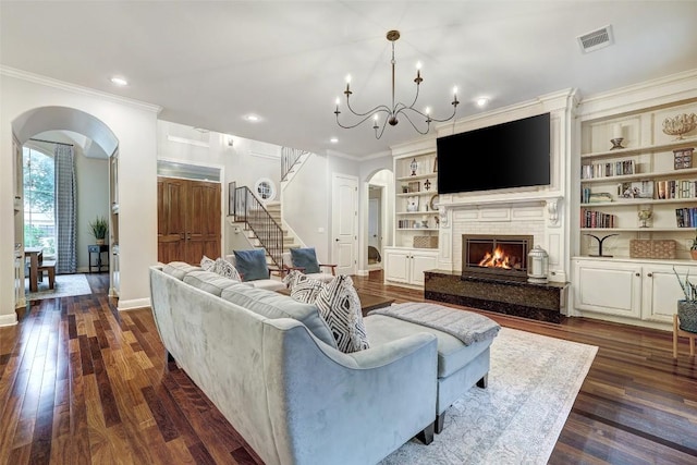 9301 San Lucas Dr, Austin, TX 78737 - living room with arched walkways, stairs, crown molding, dark wood-type flooring, and baseboards