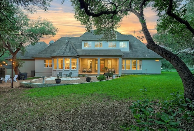 9301 San Lucas Dr, Austin, TX 78737 - rear view of house featuring a yard, a patio area, stucco siding, and roof with shingles