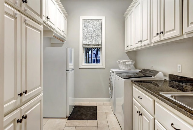 9301 San Lucas Dr, Austin, TX 78737 - laundry room featuring washer and dryer, cabinet space, light tile patterned floors, and baseboards