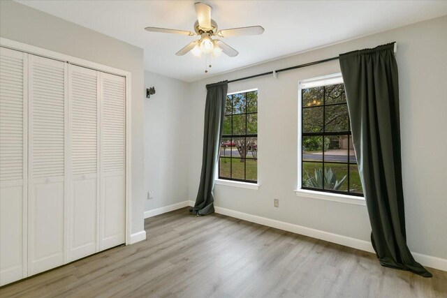 1811 Hatch Rd, Cedar Park, TX 78613 - unfurnished bedroom featuring wood finished floors, baseboards, a closet, and a ceiling fan