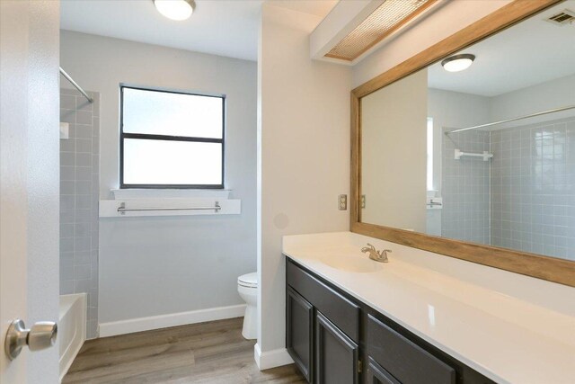 1811 Hatch Rd, Cedar Park, TX 78613 - bathroom with toilet, vanity, wood finished floors, bathing tub / shower combination, and baseboards