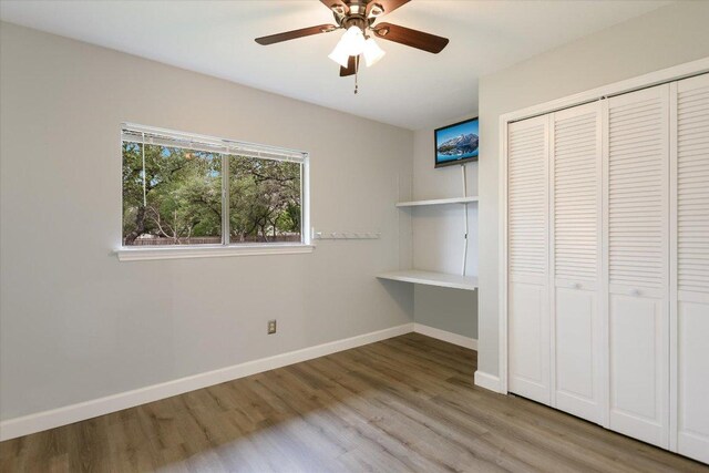 1811 Hatch Rd, Cedar Park, TX 78613 - unfurnished bedroom featuring wood finished floors, a closet, baseboards, and ceiling fan