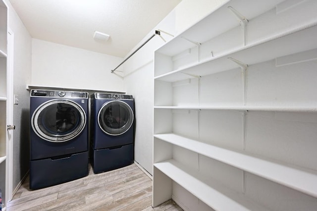 585 Siebert Dr, Kyle, TX 78640 - washroom with washer and dryer and wood finished floors
