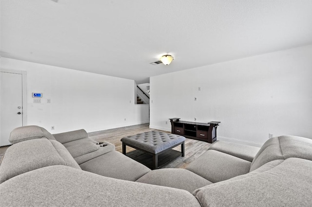 585 Siebert Dr, Kyle, TX 78640 - living area featuring wood finished floors, baseboards, and stairway