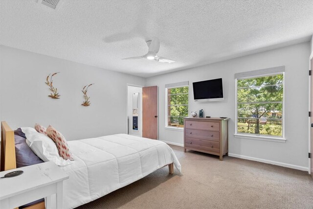 3104 Rexford Dr, Austin, TX 78723 - bedroom featuring carpet floors, a textured ceiling, baseboards, and a ceiling fan