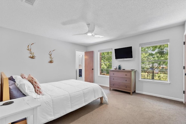 3104 Rexford Dr, Austin, TX 78723 - bedroom with carpet flooring, a textured ceiling, and a ceiling fan