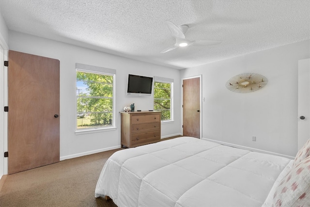 3104 Rexford Dr, Austin, TX 78723 - carpeted bedroom with a textured ceiling, baseboards, and a ceiling fan