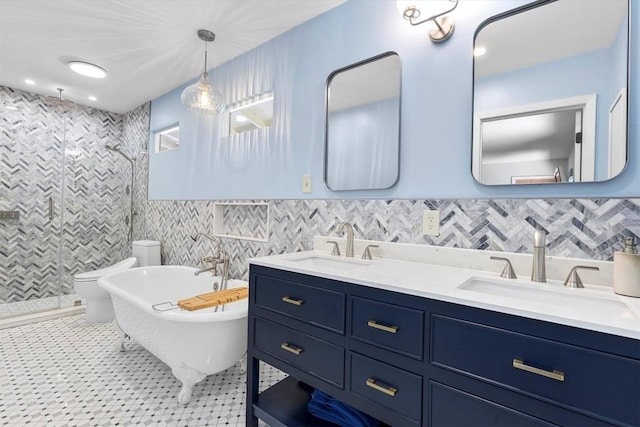 3104 Rexford Dr, Austin, TX 78723 - bathroom with a stall shower, double vanity, a soaking tub, and tile walls