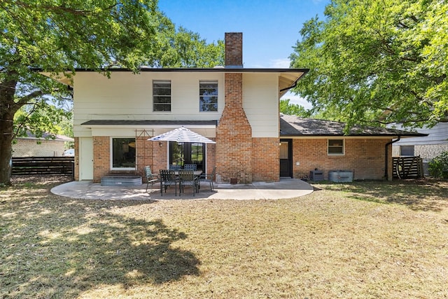 3104 Rexford Dr, Austin, TX 78723 - rear view of property featuring a chimney, brick siding, and a patio area