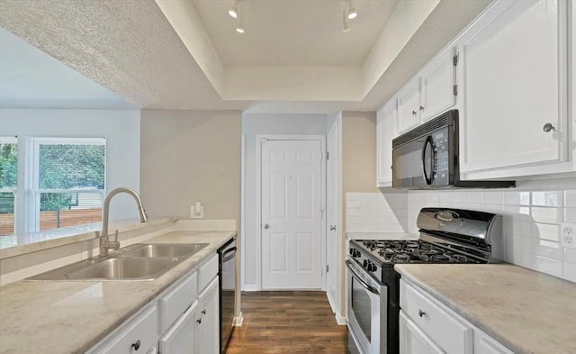 1709 Greenlawn Blvd, Round Rock, TX 78664 - kitchen with appliances with stainless steel finishes, a sink, dark wood-type flooring, white cabinets, and light countertops