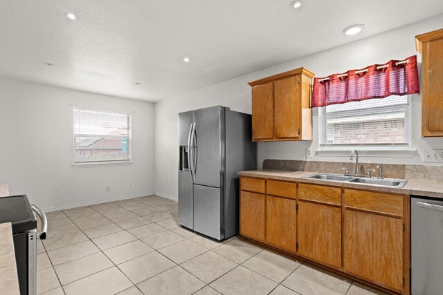 3809 Joshua Taylor Dr, Killeen, TX 76549 - kitchen with appliances with stainless steel finishes, a sink, healthy amount of natural light, light tile patterned flooring, and recessed lighting