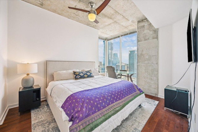 360 Nueces St Unit 3309, Austin, TX 78701 - bedroom featuring expansive windows, wood finished floors, ceiling fan, and baseboards
