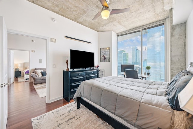 360 Nueces St Unit 3309, Austin, TX 78701 - bedroom featuring dark wood-style floors, a ceiling fan, and baseboards
