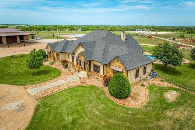 2543 Fm 975, Caldwell, TX 77836 - view of front of house with a shingled roof, stone siding, a chimney, and central AC