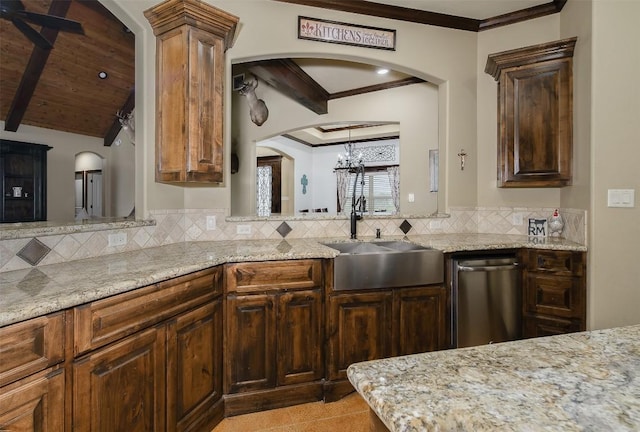 2543 Fm 975, Caldwell, TX 77836 - kitchen with a sink, arched walkways, ornamental molding, backsplash, and light stone counters