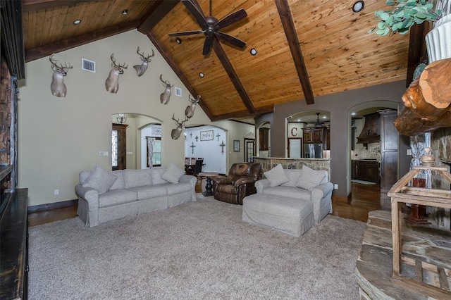 2543 Fm 975, Caldwell, TX 77836 - living area with arched walkways, ceiling fan, wooden ceiling with exposed beams, high vaulted ceiling, and baseboards