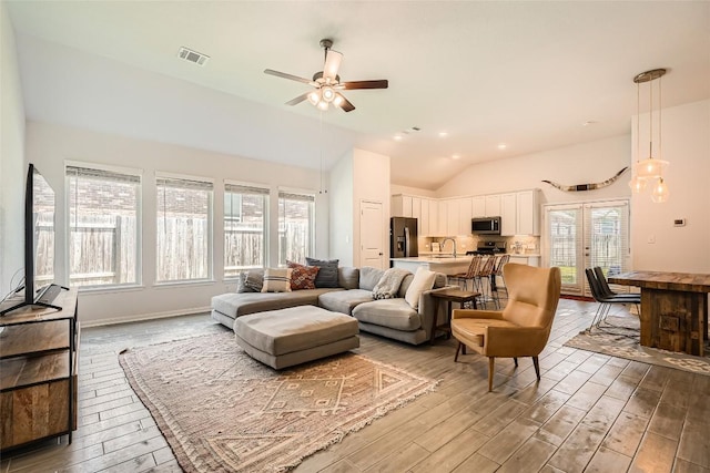 267 Razzmatazz Trl, Buda, TX 78610 - living area with light wood-style flooring, lofted ceiling, a ceiling fan, and recessed lighting
