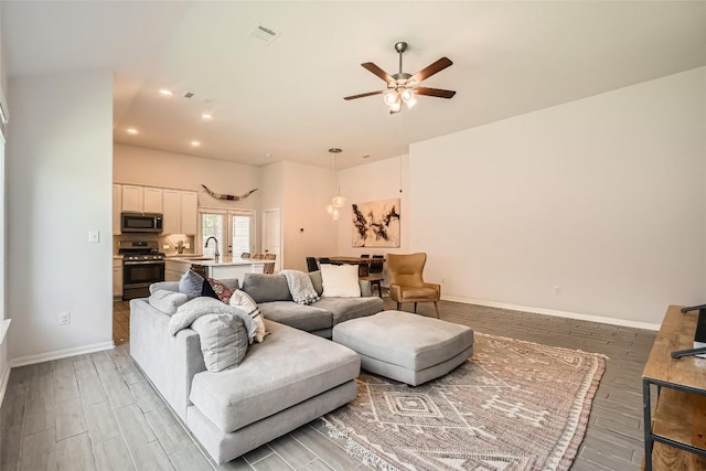 267 Razzmatazz Trl, Buda, TX 78610 - living area with light wood-type flooring, a ceiling fan, baseboards, and recessed lighting