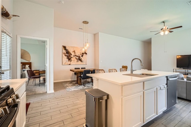 267 Razzmatazz Trl, Buda, TX 78610 - kitchen featuring light wood finished floors, a sink, open floor plan, and stainless steel dishwasher