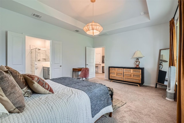 267 Razzmatazz Trl, Buda, TX 78610 - bedroom with carpet flooring, a tray ceiling, baseboards, and ensuite bath