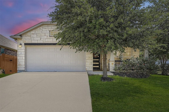 267 Razzmatazz Trl, Buda, TX 78610 - view of front of home featuring concrete driveway, a front yard, and stone siding