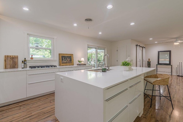 4714 Philco Dr, Austin, TX 78745 - kitchen featuring white cabinets, stainless steel gas stovetop, light wood finished floors, modern cabinets, and recessed lighting