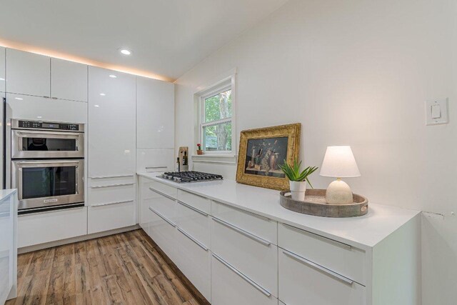 4714 Philco Dr, Austin, TX 78745 - kitchen with light wood finished floors, stainless steel appliances, modern cabinets, light countertops, and recessed lighting
