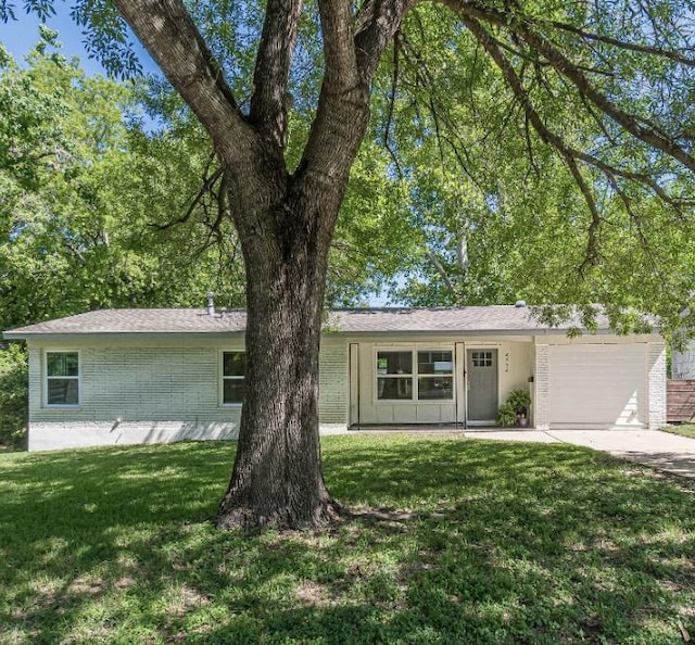 4714 Philco Dr, Austin, TX 78745 - ranch-style house with a garage, a front yard, driveway, and brick siding