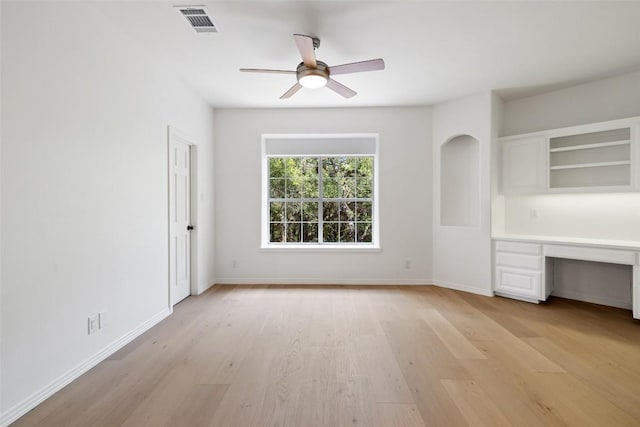 8311 Sumner Ct, Austin, TX 78733 - unfurnished bedroom featuring built in study area, light wood-style flooring, and a ceiling fan