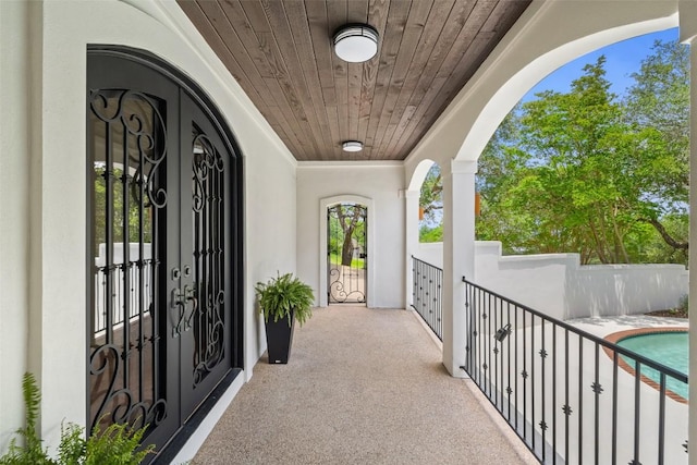 8311 Sumner Ct, Austin, TX 78733 - view of exterior entry featuring a balcony, stucco siding, and an outdoor pool