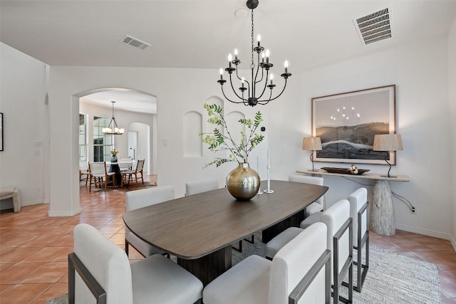 8311 Sumner Ct, Austin, TX 78733 - dining room with arched walkways, light tile patterned flooring, and a chandelier
