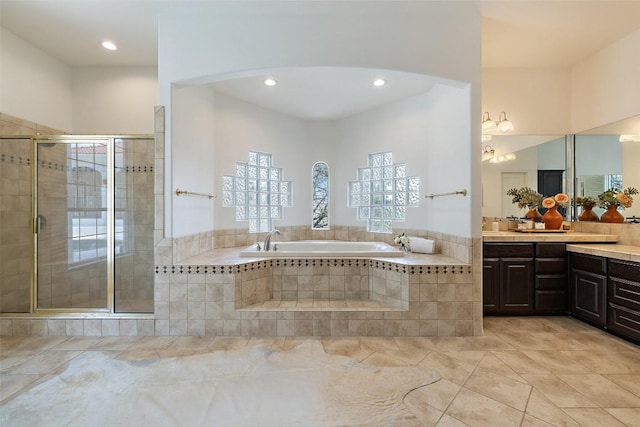 8311 Sumner Ct, Austin, TX 78733 - bathroom with vanity, a bath, a stall shower, and recessed lighting