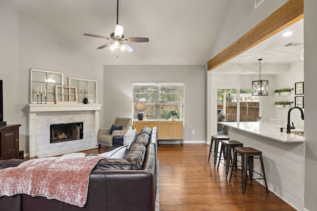 1609 Churchill Cv, Cedar Park, TX 78613 - living room featuring a ceiling fan, dark wood finished floors, a fireplace, high vaulted ceiling, and baseboards