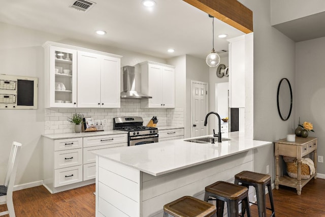 1609 Churchill Cv, Cedar Park, TX 78613 - kitchen with gas range, wall chimney exhaust hood, a sink, decorative backsplash, and recessed lighting