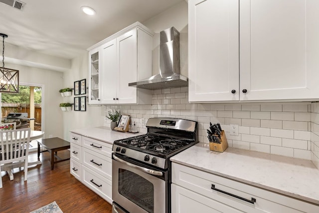 1609 Churchill Cv, Cedar Park, TX 78613 - kitchen featuring gas range, wall chimney exhaust hood, white cabinetry, glass insert cabinets, and decorative backsplash
