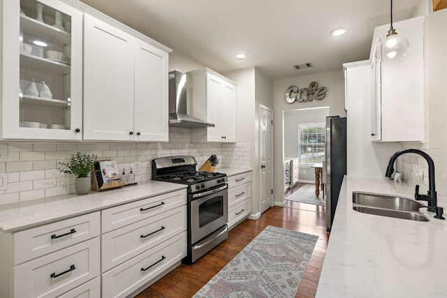 1609 Churchill Cv, Cedar Park, TX 78613 - kitchen with wall chimney exhaust hood, appliances with stainless steel finishes, a sink, white cabinetry, and recessed lighting