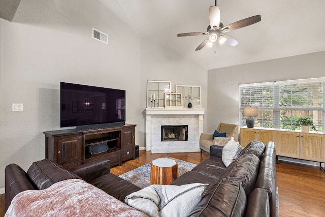 1609 Churchill Cv, Cedar Park, TX 78613 - living area featuring vaulted ceiling, wood finished floors, ceiling fan, a fireplace, and baseboards