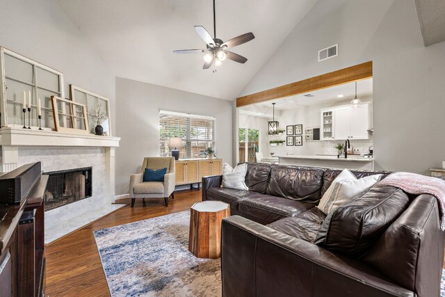 1609 Churchill Cv, Cedar Park, TX 78613 - living room featuring a ceiling fan, dark wood-style floors, high vaulted ceiling, and a high end fireplace