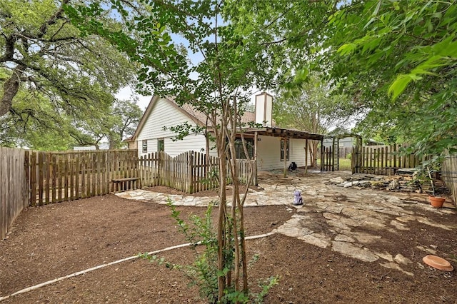 707 Shamrock Dr, Leander, TX 78641 - rear view of house featuring a fenced backyard and a chimney