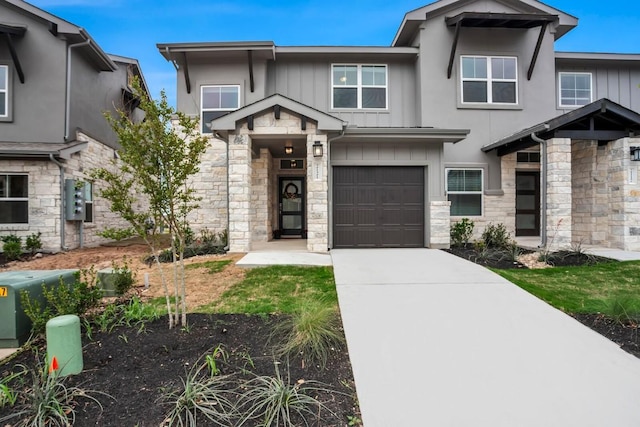 2121 Local Rebel Loop, Leander, TX 78641 - view of front facade with stone siding, a garage, concrete driveway, and board and batten siding