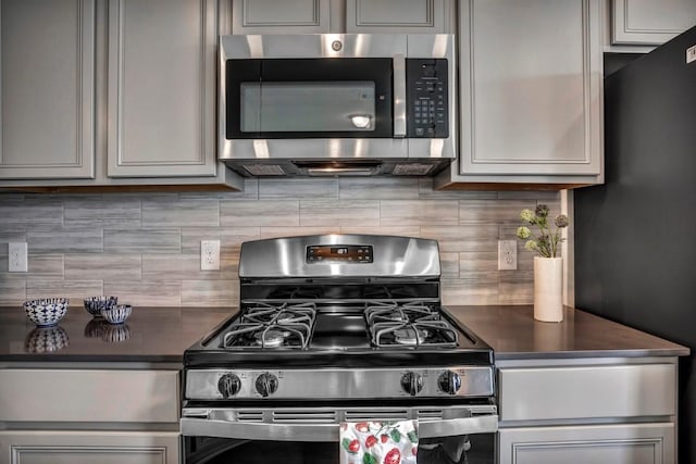 2121 Local Rebel Loop, Leander, TX 78641 - kitchen with appliances with stainless steel finishes, dark countertops, and tasteful backsplash