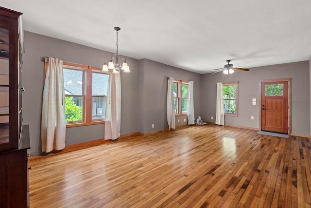 4314 Duval St, Austin, TX 78751 - unfurnished living room with light wood finished floors, a chandelier, a ceiling fan, and baseboards