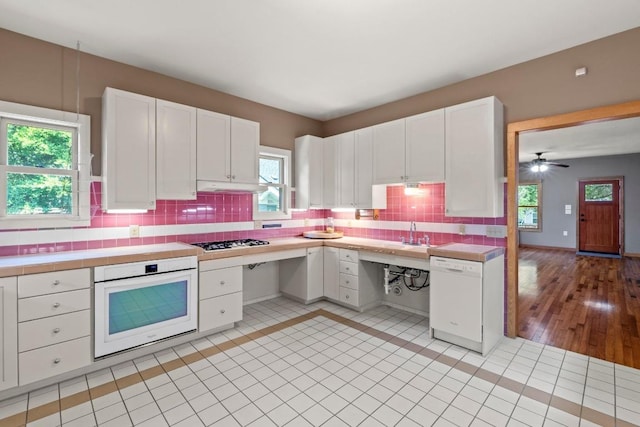 4314 Duval St, Austin, TX 78751 - kitchen with white appliances, plenty of natural light, and white cabinetry