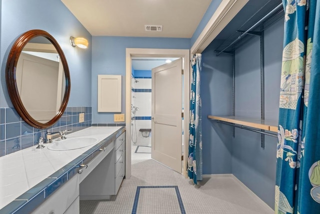 4314 Duval St, Austin, TX 78751 - bathroom with vanity, tile patterned floors, a spacious closet, and a shower with curtain