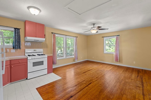 4314 Duval St, Austin, TX 78751 - kitchen with white gas range, under cabinet range hood, plenty of natural light, and backsplash