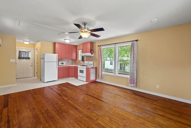 4314 Duval St, Austin, TX 78751 - kitchen with white appliances, baseboards, light wood-style floors, ceiling fan, and tasteful backsplash