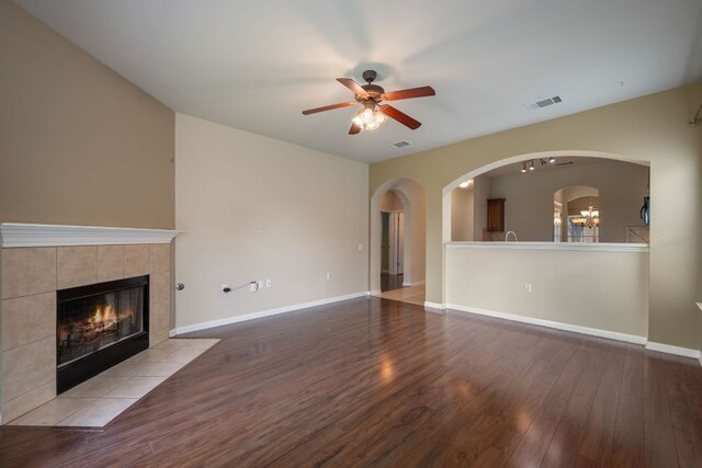 3809 Bronco Bend Loop, Austin, TX 78744 - unfurnished living room featuring a fireplace, a ceiling fan, wood finished floors, and baseboards