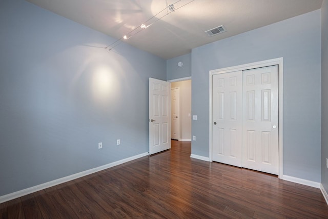 3809 Bronco Bend Loop, Austin, TX 78744 - unfurnished bedroom with wood finished floors, baseboards, and a closet