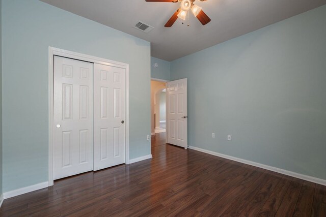 3809 Bronco Bend Loop, Austin, TX 78744 - unfurnished bedroom featuring dark wood finished floors, baseboards, a closet, and a ceiling fan